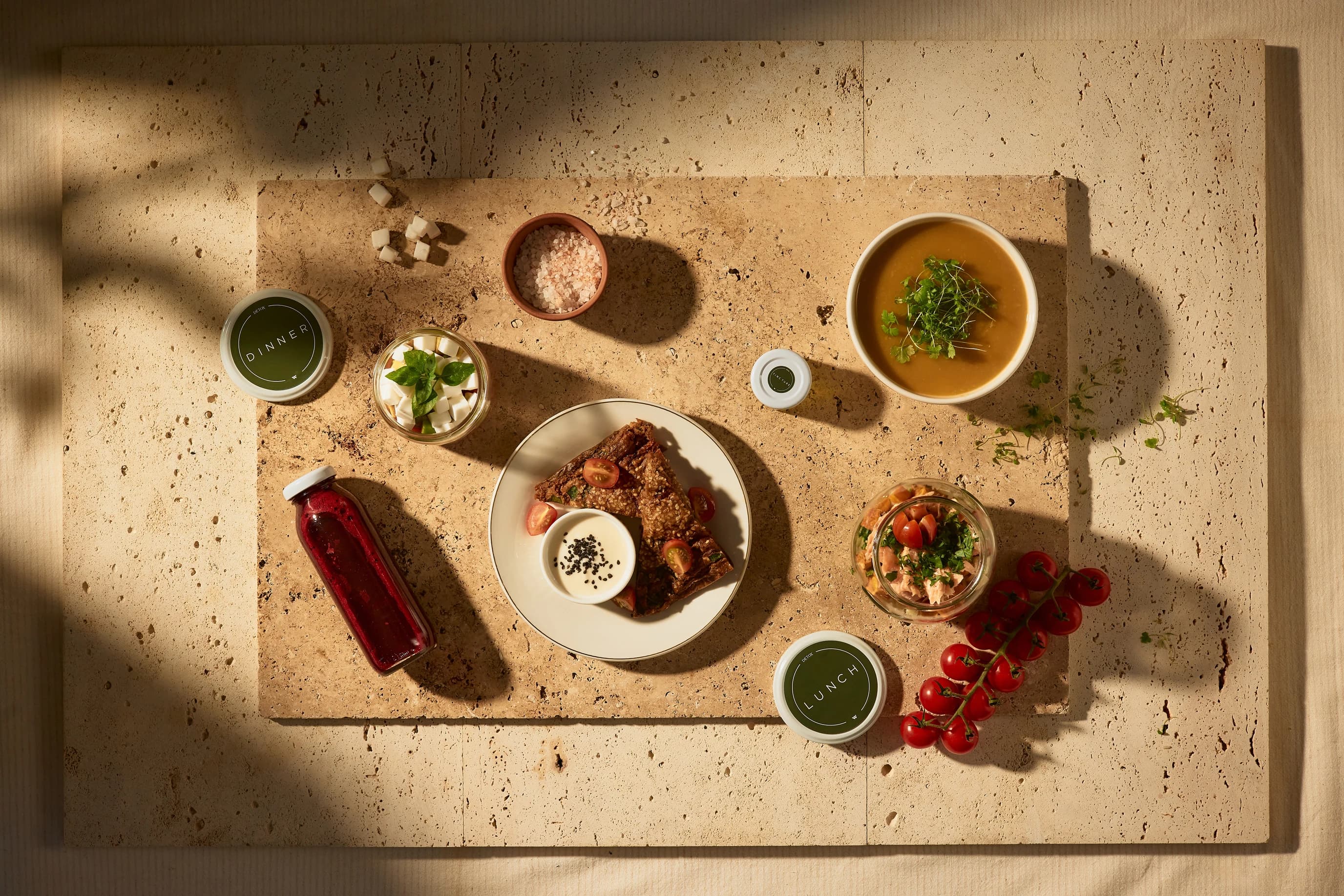 Prepared whole-food meals and juices arranged for a five-day reset